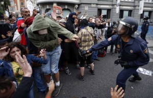 http://ca.news.yahoo.com/photos/anti-austerity-protests-in-spain-slideshow/policeman-clubs-protester-police-charged-demonstrators-outside-spanish-photo-175854650.html