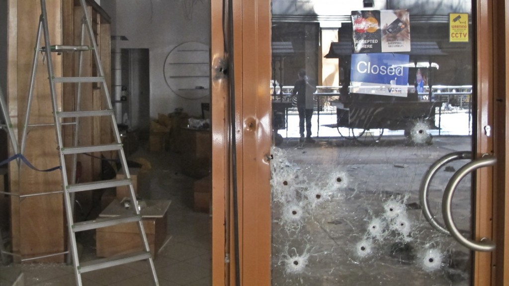 Bullet holes in the glass door of a shop in the Westgate Mall in Nairobi, Kenya. Photo by Associated Press.