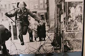 Soldier jumping over barbed wire from East Berlin to West. Source: russiawithlove.blogspot.com