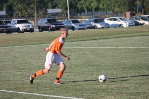 Action shot picture of Jacob Jones in his freshmen year of soccer. Also, has a  mo-hawk hair style. 