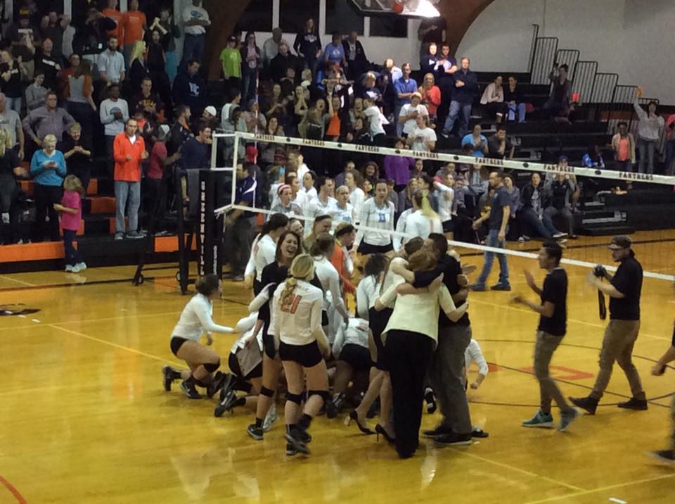 The GC Volleyball team storms the court after winning the SLIAC championship.  Photo by GC Papyrus.