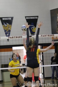 Riley Hannula goes for the block during the SLIAC tournament.  Photo by Bilinski Bros.