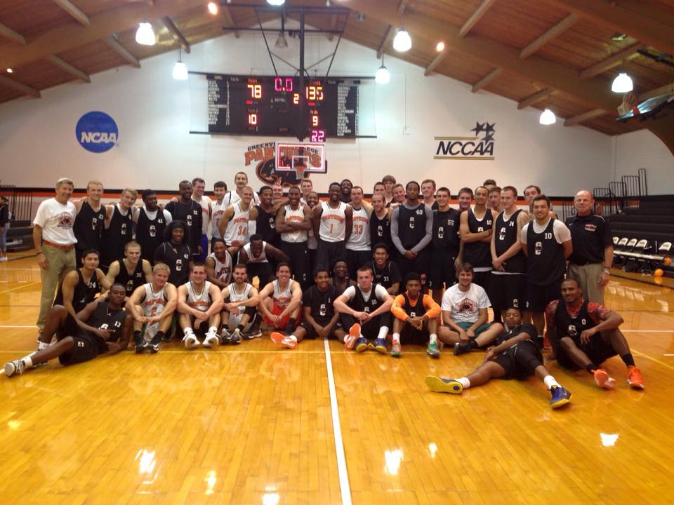 Greenville Men's Basketball team with the Alumni. Image by Greenville Men's Basketball Facebook Page.