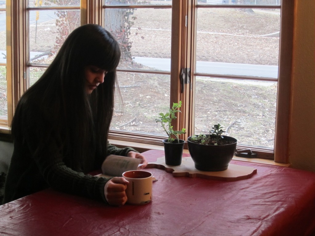 A student sits drinking coffee.