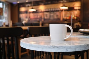 Coffee mug sitting in an empty coffee shop