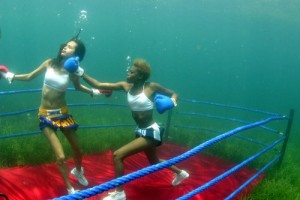 Ladies taking punches at each other in a underwater boxing match. Image from creativeherald.com