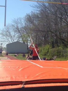 Phil Wisman running down the pole vault lane and about to jump. Image by Austin Brinkman 