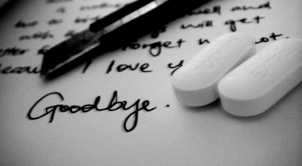 Suicide note, pen, and pills